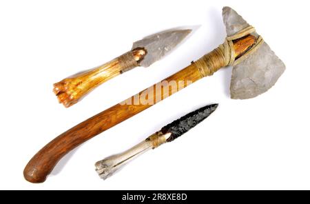 Stone Age Tools on white Background - Stone Age Axe, Knives and Arrows Stock Photo