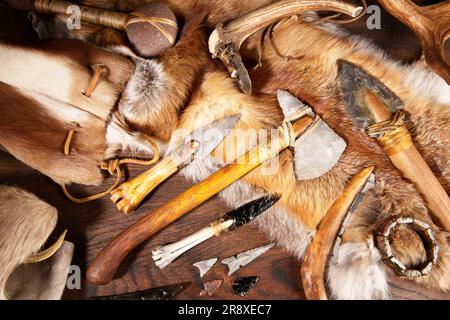Stone Age Tools on wooden Background Stock Photo