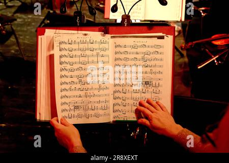 Image of sheet music for violin on music stand in orchestra pit Stock Photo