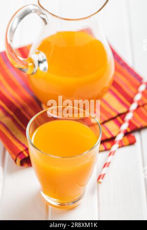 A glass of fruit juice. Orange  juice on the white table. Stock Photo