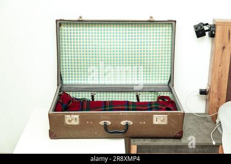Old vintage suitcase fashionable in the 1960s. Isolated on white. Stock Photo