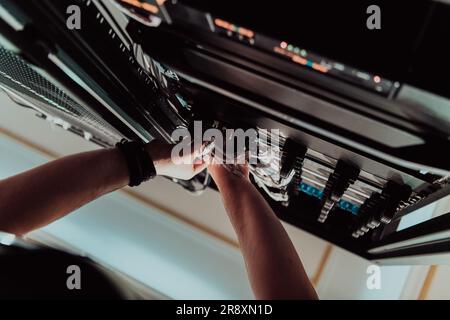 Close up of technician setting up network in server room  Stock Photo
