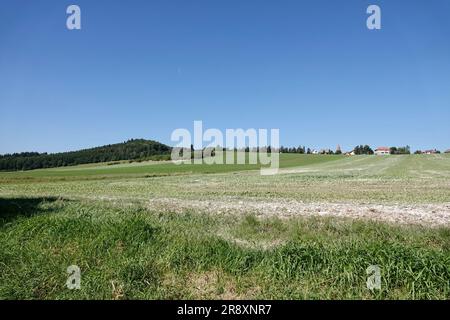 View of the village of Blazov and the surrounding fields near the village and the famous Bouzov Castle. Strawberry Hill - Jahodova hora - can be seen Stock Photo