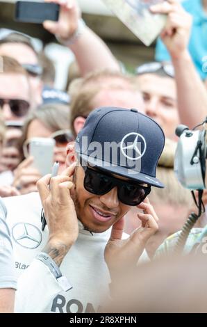 Lewis Hamilton, Mercedes Formula 1 Grand Prix racing driver at the noisy Goodwood Festival of Speed motorsport event. Surrounded by autograph hunters Stock Photo