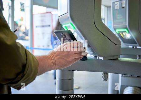 Person using qr code or smartphone app to enter an airport or convention hall, office, or any area with security control Stock Photo