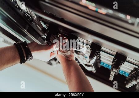 Close up of technician setting up network in server room  Stock Photo