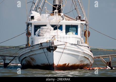 Commercial fishing boats have been converted to oil cleanup crews as part of the 'vessels of opportunity' program managed by BP. Stock Photo