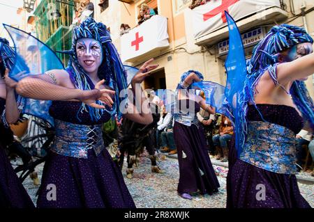 Women in fanciful costumes, loosely representing the North African tribes, the Moors, dance while marching in a parade during the Festival of Moors and Christians, (La Fiesta de Mo Stock Photo