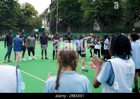 (L-R) Michael Gallup from the NFL team Dallas Cowboys, Josh Uche from the NFL team New England Patriots, Clyde Edwards-Helaire from the NFL team Kansas City Chiefs, Jamel Dean from the NFL team Tampa Bay Buccaneers, Kevin Byard from the NFL team Tennessee Titans and Efe Obada from the NFL team Washington Commanders interacts with students during a visit to Gladesmore Community School, London. Stock Photo