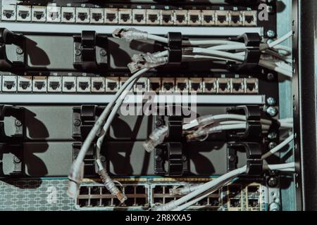 Close up of technician setting up network in server room  Stock Photo