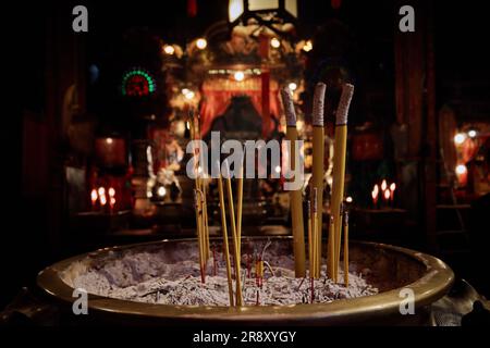 Hong Kong - April 24 2023: Incense Sticks in burner inside the Man Mo Temple Stock Photo