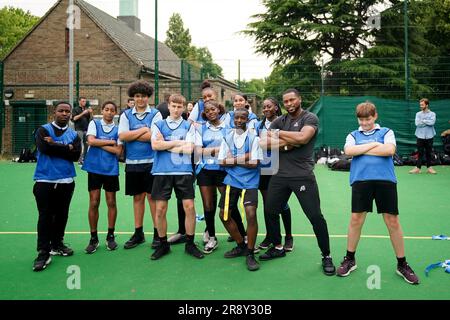 Kevin Byard from the NFL team Tennessee Titans poses for a photo with students during a visit to Gladesmore Community School, London. Stock Photo