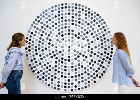 London, UK.  23 June 2023. Staff members in front of ‘Decahydronapthalene’, 2019, by Damien Hirst (Est. £250,000-350,000) at a preview of highlights of the ‘20th Century to Now’ sale at Phillips.  20th century masters, post-war works and contemporary pieces will be auctioned at Phillips’ Berkeley Square galleries on 30 June.  Credit: Stephen Chung / Alamy Live News Stock Photo