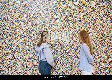 London, UK.  23 June 2023. Staff members with ‘Toddler’s Cloud’, 2016, by Damien Hirst (Est. £400,000-600,000) at a preview of highlights of the ‘20th Century to Now’ sale at Phillips.  20th century masters, post-war works and contemporary pieces will be auctioned at Phillips’ Berkeley Square galleries on 30 June.  Credit: Stephen Chung / Alamy Live News Stock Photo