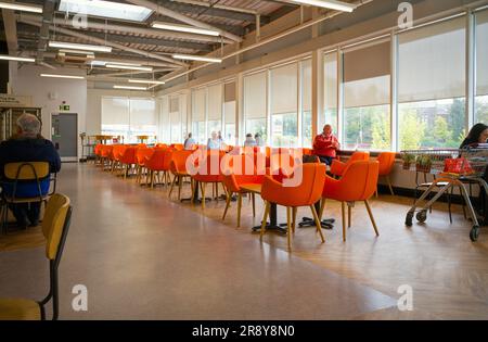 Bright orange seating at the Sainsbury's cafe in the Falsgrove area of Scarborough Stock Photo