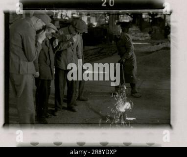 SS photographer Cantzler captured the stark reality of Russia in 1943. The images depict a shipyard, a destroyed factory, a foundry, a schwimmwagen, heavy artillery, panzers accompanied by infantry (including Tiger I tanks and StuGs), a sniper team, and intimate soldier portrait shots Stock Photo