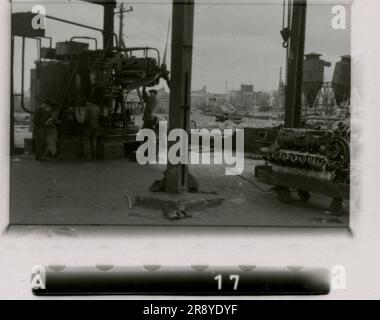 SS photographer Cantzler captured the stark reality of Russia in 1943. The images depict a shipyard, a destroyed factory, a foundry, a schwimmwagen, heavy artillery, panzers accompanied by infantry (including Tiger I tanks and StuGs), a sniper team, and intimate soldier portrait shots Stock Photo