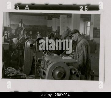 SS photographer Cantzler captured the stark reality of Russia in 1943. The images depict a shipyard, a destroyed factory, a foundry, a schwimmwagen, heavy artillery, panzers accompanied by infantry (including Tiger I tanks and StuGs), a sniper team, and intimate soldier portrait shots Stock Photo