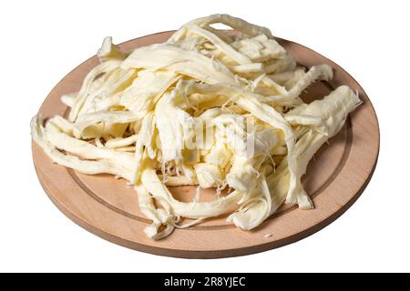 String cheese isolated on white background. Cecil cheese on a wood serving board. Dairy products Stock Photo