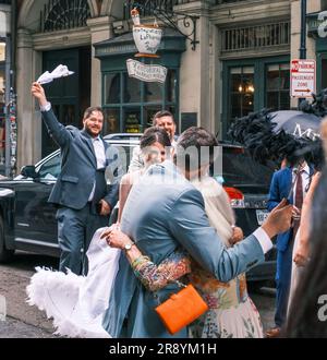 NEW ORLEANS, LA, USA - JUNE 3, 2023: Groom hugs his mother at the end of the second line parade celebrating his marriage, in the French Quarter Stock Photo