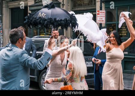 NEW ORLEANS, LA, USA - JUNE 3, 2023: Bride hugs her new mother-in-law at the end of second line parade celebrating the wedding, in the French Quarter Stock Photo