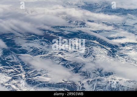 Aerial view at 38,000 feet of part of the mountains and hills on landmass of Nunavut, a territory of northern Canada, forming most of the Canadian Arc Stock Photo