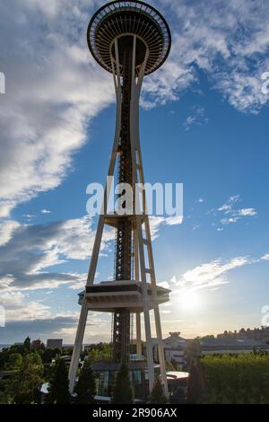 Seattle, WA, USA-July 2022; Low angle view of the Space Needle during sunset with the sun shining brightly through the clouds Stock Photo