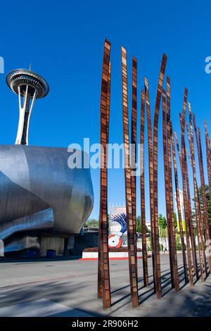 Seattle, WA, USA-July 2022; Low angle vertical view of wall of steel blades artwork Grass Blades by John Fleming with sheet-metal façade of Museum of Stock Photo