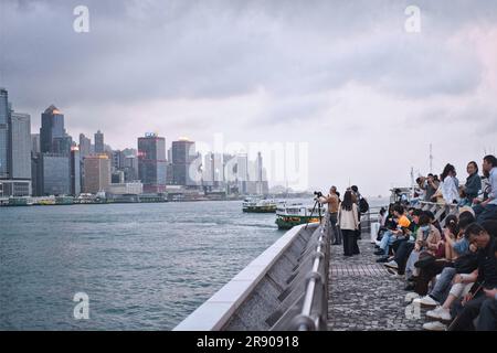 Hong Kong, China - April 24 2023: People waiting light and music show on the kowloon seaside promenade Stock Photo