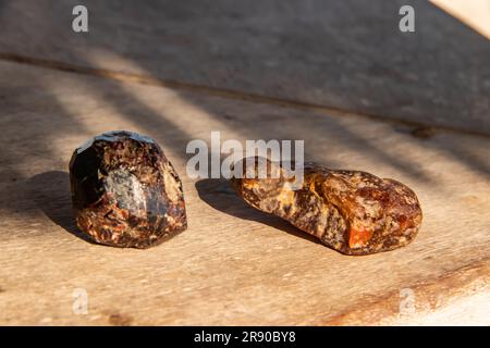 Natural unpolished marble brown stone showcases earthy hues with distinctive veining, offering a rugged and organic appearance. Stock Photo