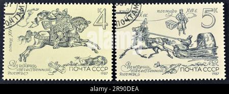 Cancelled postage stamps printed by Soviet Union, that show History of Russian Postal Service, circa 1987. Stock Photo