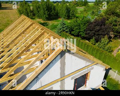 Aerial view on single family house finished roof wooden construction decorated with a wreath Stock Photo