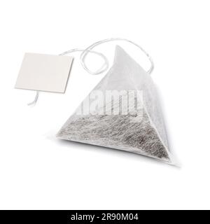 Single pyramid tea bag and blank label isolated on white background close up Stock Photo