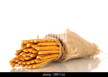 Straw is a bakery product. Several straws with a jute bag isolated on a white background Stock Photo