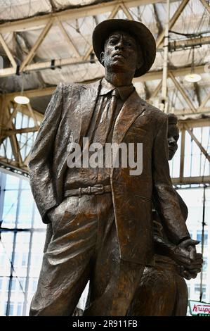 London, UK. 23rd June 2023. Floral tributes were laid on the Basil Watson statue that forms the National Windrush Monument in Waterloo Station, to celebrate Windrush Day on 22nd June. Credit: michael melia/Alamy Live News Stock Photo