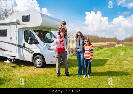 Family vacation, RV travel with kids, happy parents with children have fun on holiday trip in motorhome, camper exterior Stock Photo