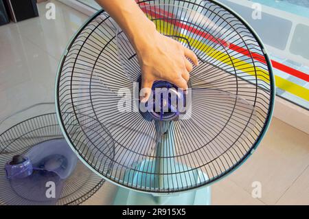 Technician repairing fan, replacing impeller Stock Photo