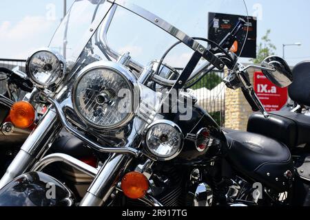 headlight closeup of popular large American made motorcycle. glass lens and shiny chrome finish. shiny stainless steel crash bar and engine guard. Stock Photo