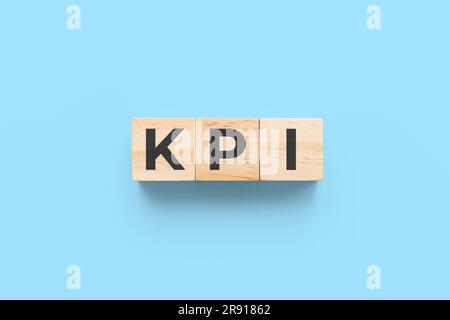 KPI (key performance indicator) wooden cubes on blue background Stock Photo
