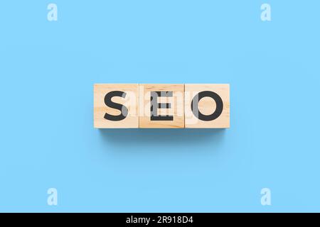 SEO (search engine optimization) wooden cubes on blue background Stock Photo