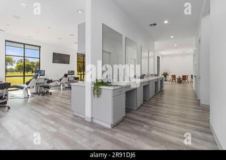 A modern dental office interior featuring multiple comfortable dental chairs and sinks Stock Photo