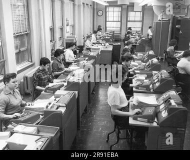 Cleveland, Ohio:  January 22, 1958 Women office workers entering data using tabulating machines and punch cards at the Erie Railroad Company offices. Stock Photo