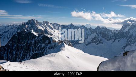 An aerial view of the beautiful snowy jagged Aiguille du Midi mountains ...