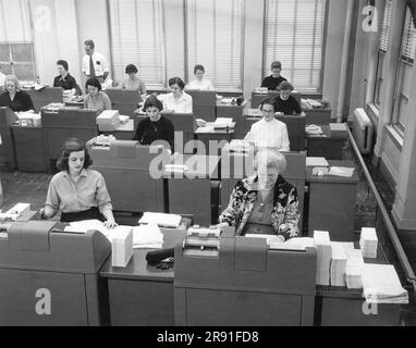 Cleveland, Ohio:  January 22, 1958 Women office workers entering data using tabulating machines and punch cards at the Erie Railroad Company offices. Stock Photo