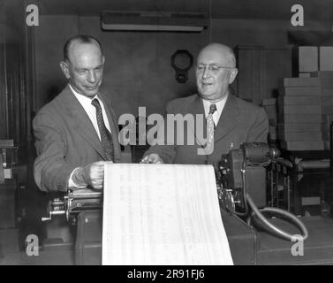 Cleveland, Ohio:  1951 Executives viewing printed out data sheets at the Erie Railroad offices. Stock Photo