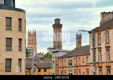 towers of trinity church and park circus viewed over the tenements of the city Stock Photo