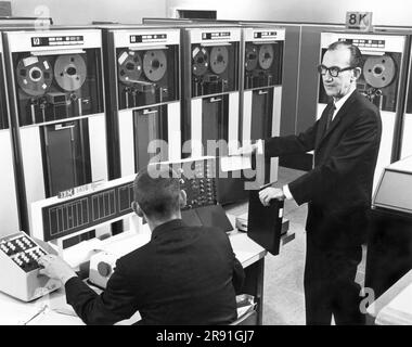 Pontiac, Michigan:  c. 1962 Engineers at the GMC Truck Division use an IBM digital computer in place of field tests to evaluate braking systems. Stock Photo