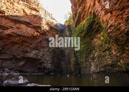 Tourists enjoy a swim in the fresh waters of Emma Gorge in Western Australia Stock Photo