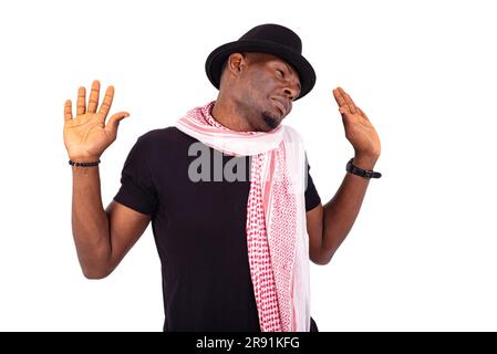 young man wearing hat and scarf, gesturing his hands. Stock Photo