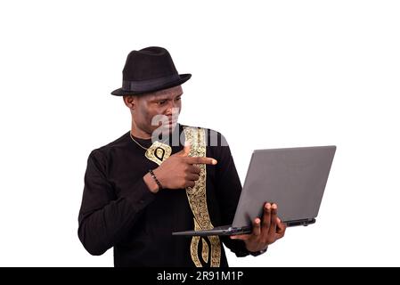 well-dressed young man pointing finger at laptop screen. Stock Photo